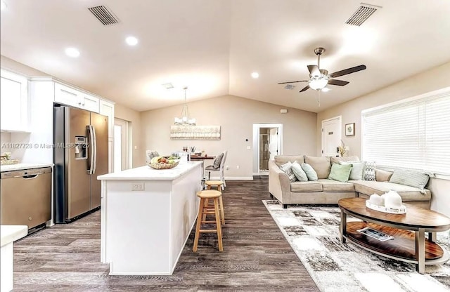 220 Kite Ave, Sebring, FL 33870 - living room featuring a ceiling fan, dark wood-style flooring, vaulted ceiling, a chandelier, and plenty of natural light