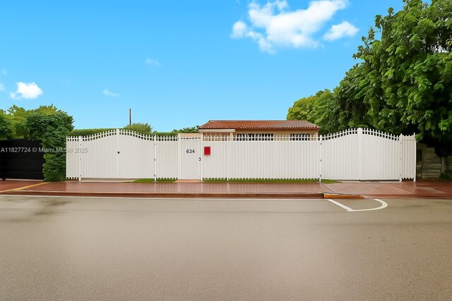 634 82nd St, Miami Beach, FL 33141 - view of front of home featuring a gate and a tiled roof