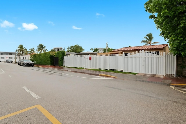 634 82nd St, Miami Beach, FL 33141 - view of asphalt street with a gate, curbs, and sidewalks