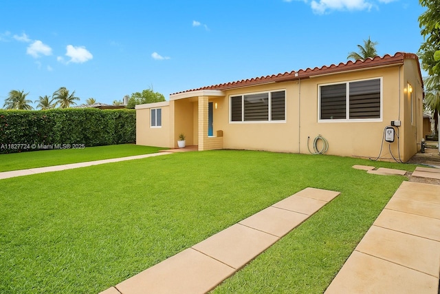 634 82nd St, Miami Beach, FL 33141 - view of front facade with stucco siding and a tiled roof