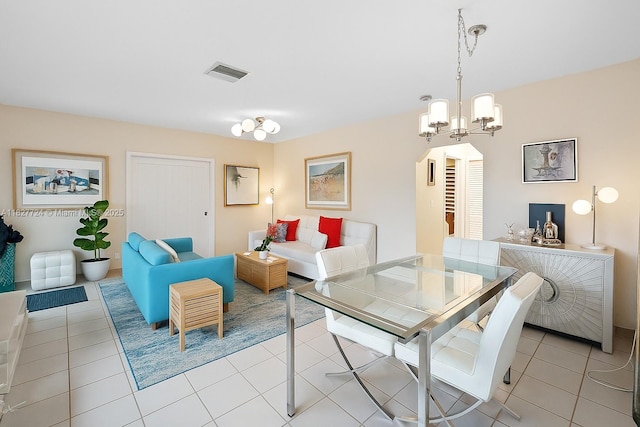 634 82nd St, Miami Beach, FL 33141 - dining space featuring arched walkways, a chandelier, and light tile patterned flooring