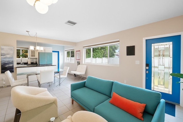 634 82nd St, Miami Beach, FL 33141 - living room featuring a chandelier and light tile patterned floors