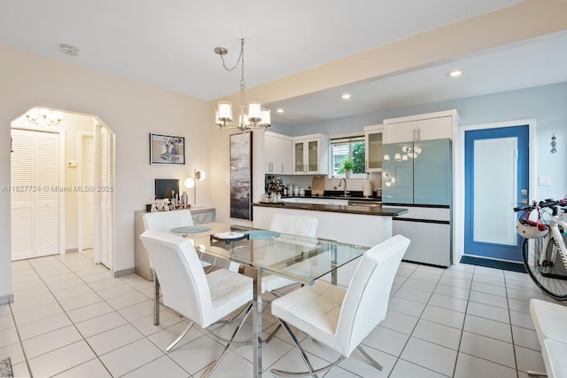 634 82nd St, Miami Beach, FL 33141 - dining space featuring a chandelier, recessed lighting, light tile patterned floors, and arched walkways