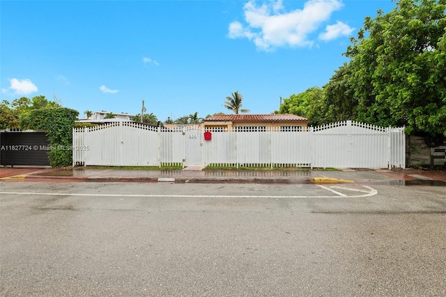 634 82nd St, Miami Beach, FL 33141 - view of front facade featuring a gate and uncovered parking