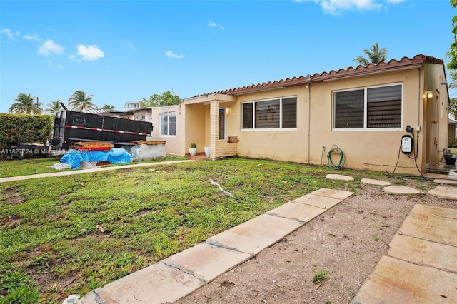 634 82nd St, Miami Beach, FL 33141 - view of front of property featuring stucco siding, a front lawn, and a tiled roof