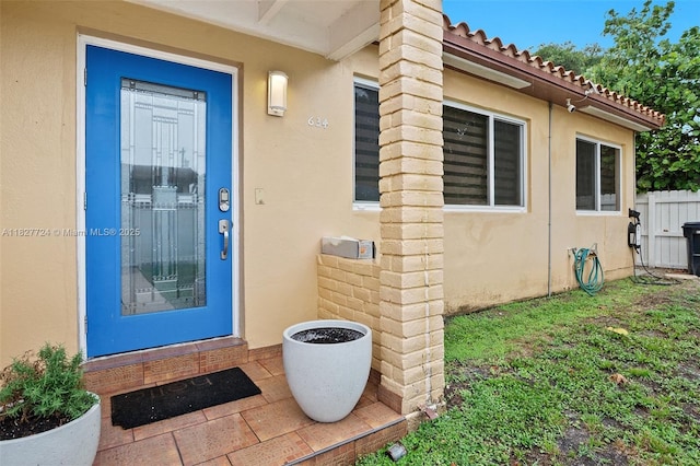 634 82nd St, Miami Beach, FL 33141 - doorway to property featuring stucco siding and a tile roof