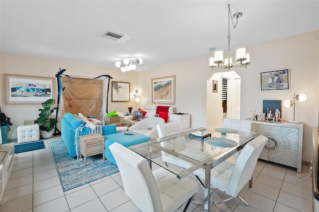 634 82nd St, Miami Beach, FL 33141 - dining space featuring a chandelier, light tile patterned floors, and arched walkways