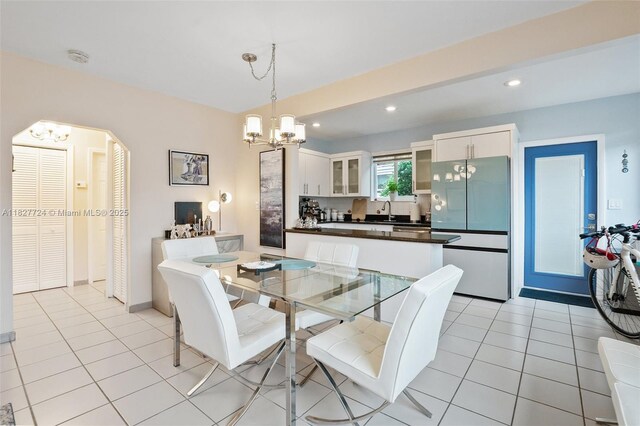 634 82nd St, Miami Beach, FL 33141 - dining space featuring a chandelier, recessed lighting, arched walkways, and light tile patterned floors