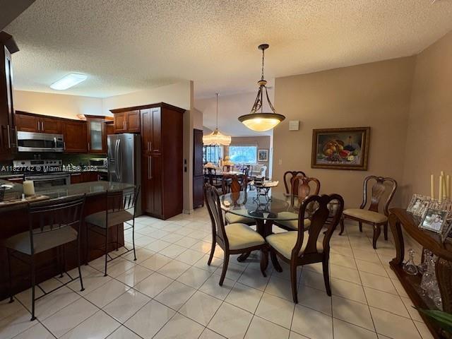 13736 SW 12th St, Miami, FL 33184 - dining space featuring a textured ceiling and light tile patterned floors