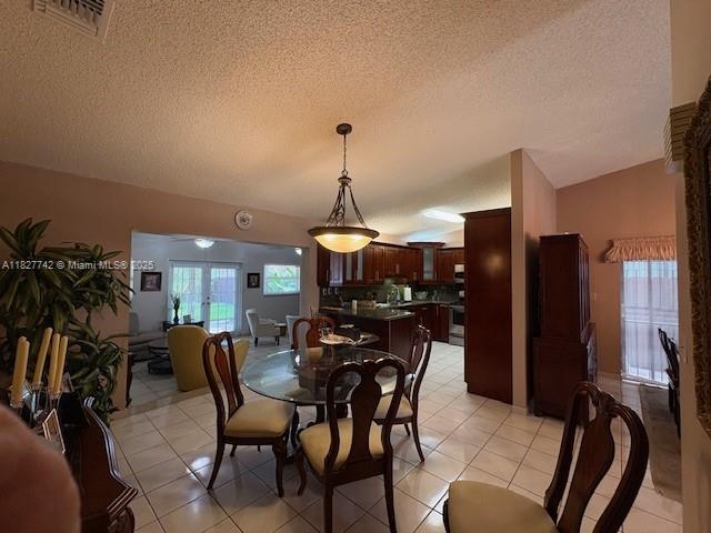 13736 SW 12th St, Miami, FL 33184 - dining room with a textured ceiling and light tile patterned floors