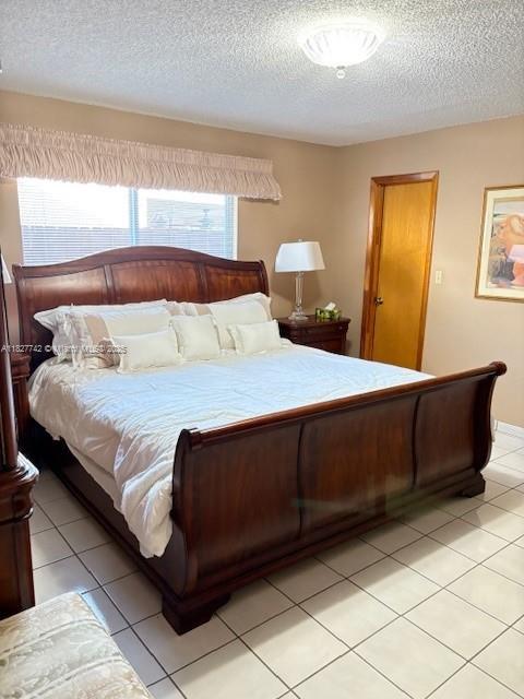13736 SW 12th St, Miami, FL 33184 - bedroom featuring a textured ceiling and light tile patterned floors