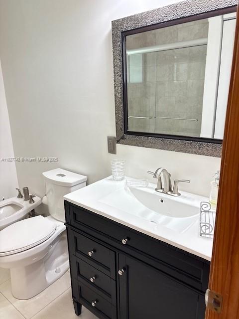 13736 SW 12th St, Miami, FL 33184 - bathroom with vanity, a bidet, and tile patterned flooring