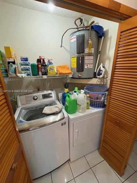 13736 SW 12th St, Miami, FL 33184 - washroom with electric water heater, washer and dryer, and light tile patterned floors