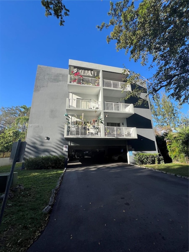645 NE 121st St Unit 404, North Miami, FL 33161 - view of property featuring a carport