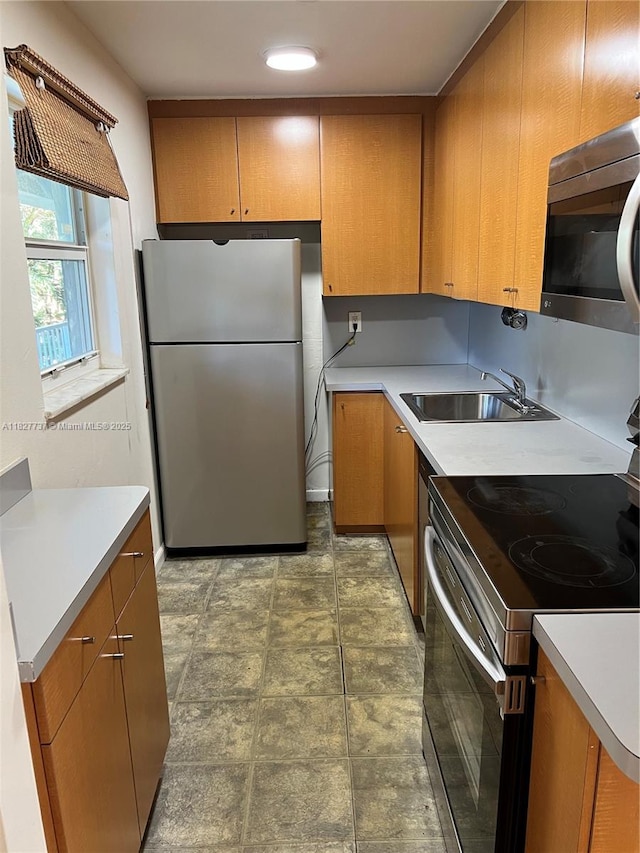 645 NE 121st St Unit 404, North Miami, FL 33161 - kitchen featuring stainless steel appliances, light countertops, stone finish flooring, and brown cabinetry