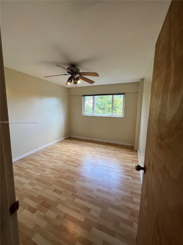 645 NE 121st St Unit 404, North Miami, FL 33161 - spare room featuring a ceiling fan and light wood-style floors