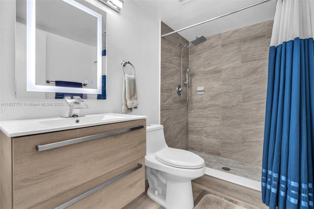 9525 Weldon Cir Unit H305, Tamarac, FL 33321 - bathroom with vanity, a tile shower, and wood finished floors