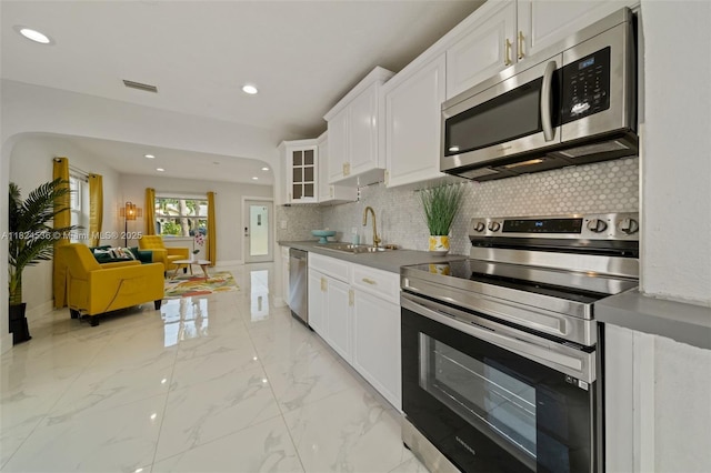2714 Fillmore St, Hollywood, FL 33020 - kitchen with appliances with stainless steel finishes, backsplash, recessed lighting, and white cabinets