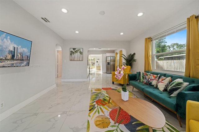 2714 Fillmore St, Hollywood, FL 33020 - living room with arched walkways, light marble finish floors, and recessed lighting