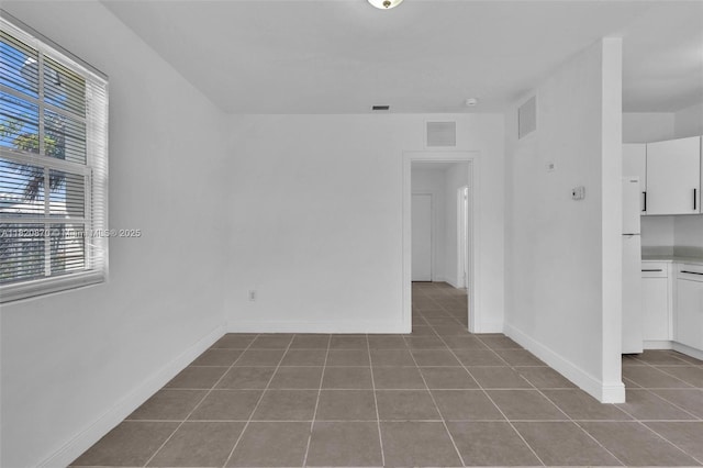 750 84th St, Miami Beach, FL 33141 - tiled empty room with baseboards