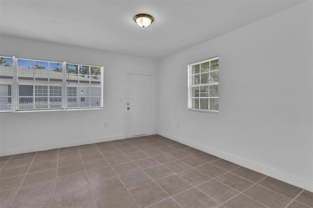 750 84th St, Miami Beach, FL 33141 - empty room featuring tile patterned floors and baseboards
