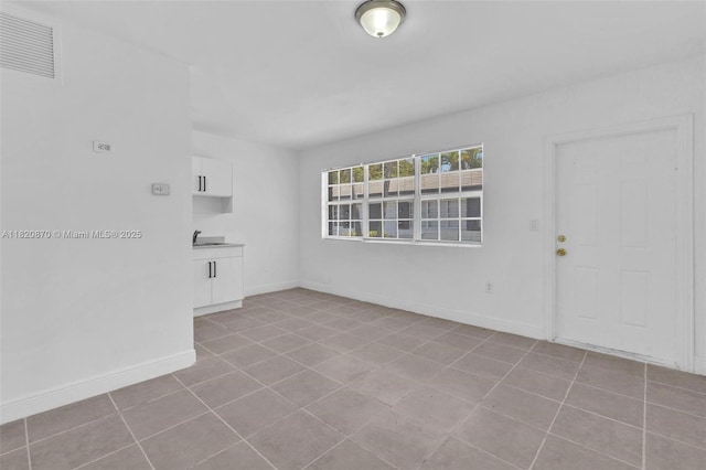 750 84th St, Miami Beach, FL 33141 - tiled spare room featuring baseboards
