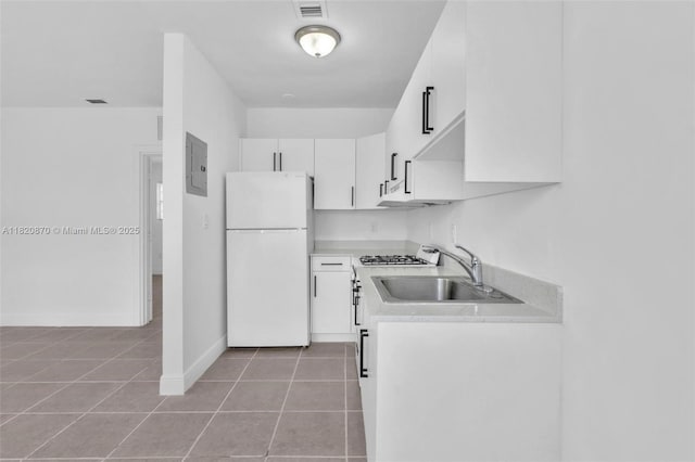 750 84th St, Miami Beach, FL 33141 - kitchen featuring freestanding refrigerator, electric panel, light tile patterned floors, white cabinetry, and light countertops