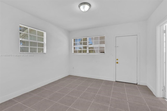 750 84th St, Miami Beach, FL 33141 - empty room featuring tile patterned floors and baseboards
