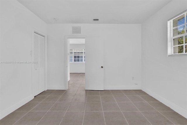 750 84th St, Miami Beach, FL 33141 - tiled spare room with baseboards