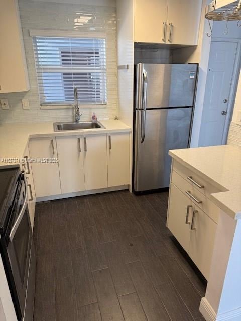 947 Lenox Ave Unit 502, Miami Beach, FL 33139 - kitchen with freestanding refrigerator, electric stove, and white cabinets