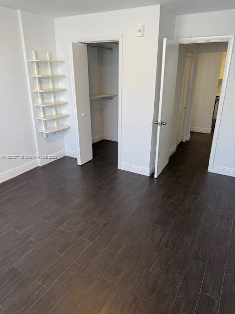 947 Lenox Ave Unit 502, Miami Beach, FL 33139 - unfurnished bedroom featuring dark wood-style flooring and a closet