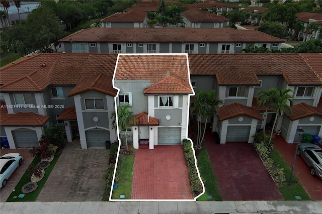 2872 SW 127th Way Unit 1, Miramar, FL 33027 - mediterranean / spanish home featuring a tiled roof, driveway, a residential view, and stucco siding