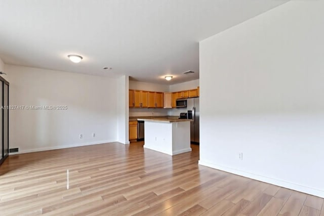 2872 SW 127th Way Unit 1, Miramar, FL 33027 - unfurnished living room with light wood finished floors and baseboards