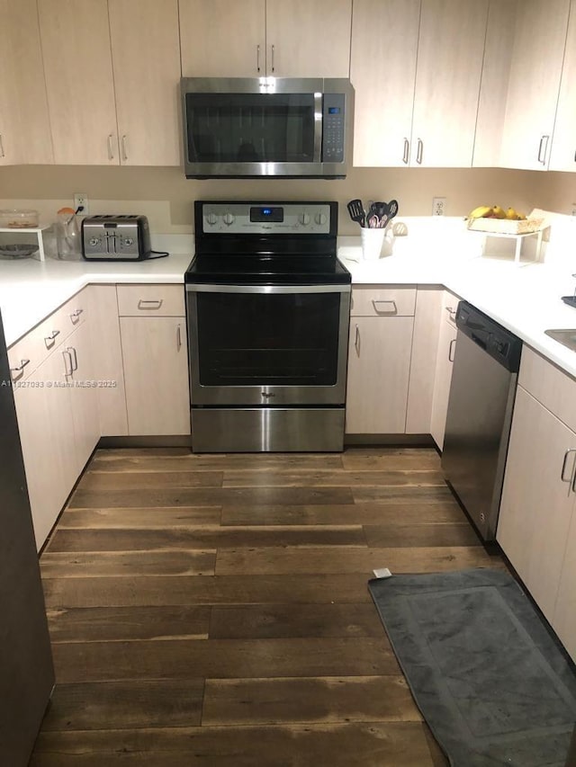 50 Menores Ave Unit 711, Coral Gables, FL 33134 - kitchen with appliances with stainless steel finishes, dark wood-type flooring, and light countertops