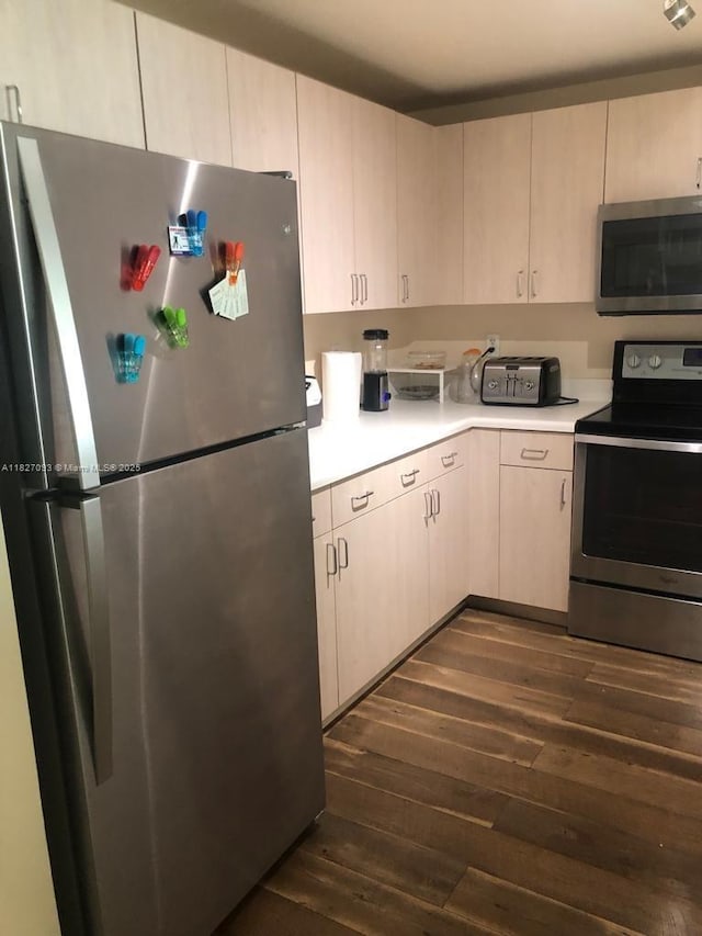 50 Menores Ave Unit 711, Coral Gables, FL 33134 - kitchen with appliances with stainless steel finishes, dark wood finished floors, light countertops, and light brown cabinets