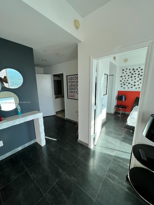 60 SW 13th St Unit 3407, Miami, FL 33130 - hallway with dark tile patterned floors and baseboards