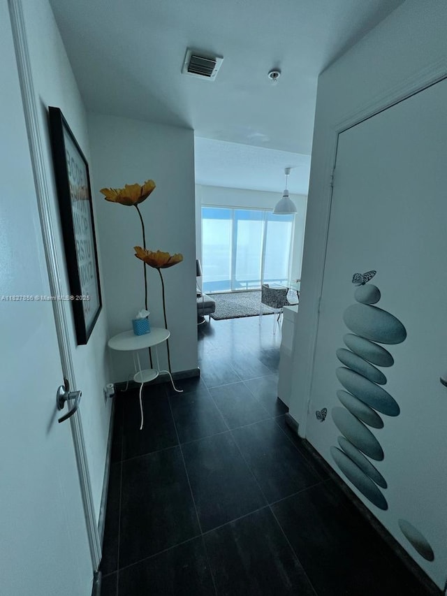60 SW 13th St Unit 3407, Miami, FL 33130 - hallway featuring dark tile patterned floors and baseboards