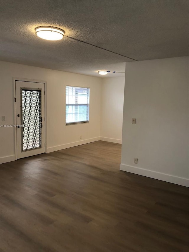 850 SW 133rd Ter Unit 302B, Pembroke Pines, FL 33027 - empty room featuring dark wood finished floors and a textured ceiling