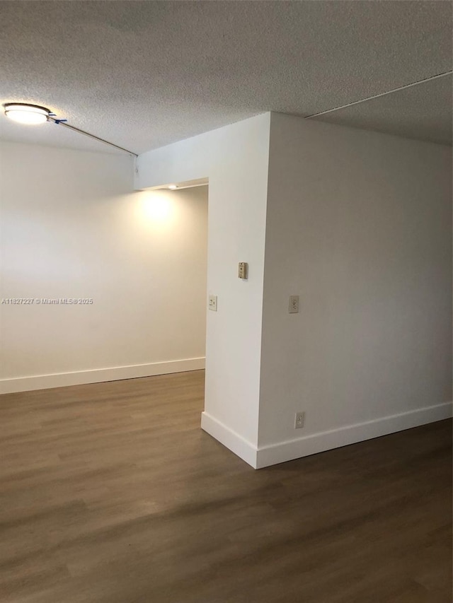 850 SW 133rd Ter Unit 302B, Pembroke Pines, FL 33027 - empty room with dark wood finished floors and a textured ceiling