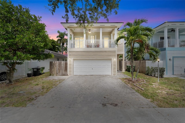 371 NE 32nd Ter, Homestead, FL 33033 - view of front facade featuring a balcony, decorative driveway, a garage, and ceiling fan