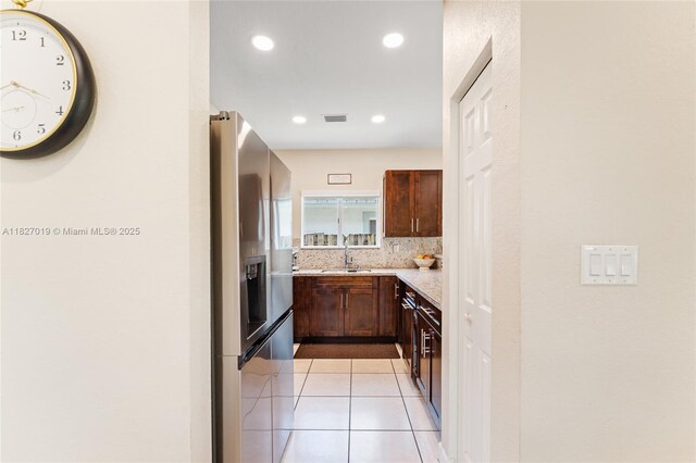 371 NE 32nd Ter, Homestead, FL 33033 - kitchen with stainless steel refrigerator with ice dispenser, backsplash, light tile patterned flooring, and recessed lighting
