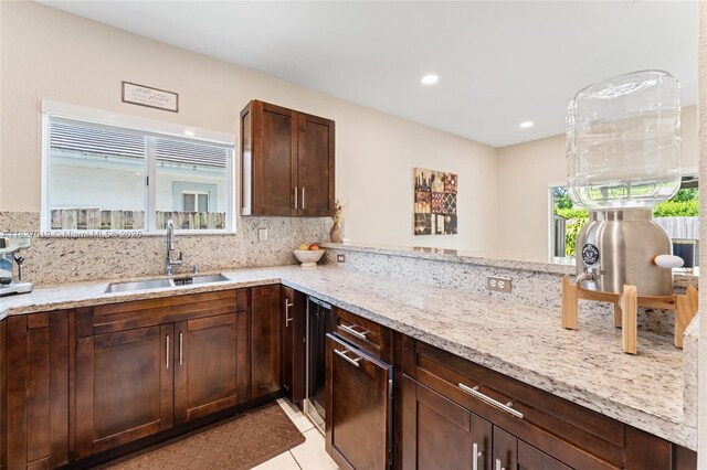 371 NE 32nd Ter, Homestead, FL 33033 - kitchen with light stone counters, backsplash, recessed lighting, light tile patterned floors, and dark brown cabinetry
