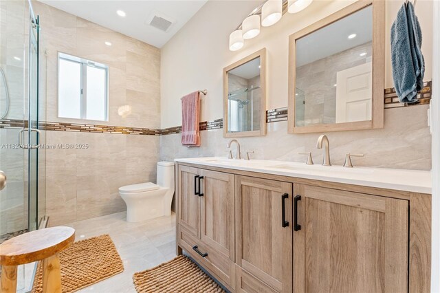 371 NE 32nd Ter, Homestead, FL 33033 - bathroom with tile walls, a stall shower, and double vanity