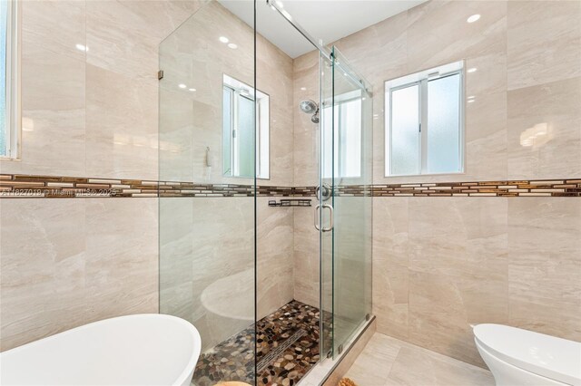 371 NE 32nd Ter, Homestead, FL 33033 - full bathroom with tile walls, a freestanding tub, and a stall shower