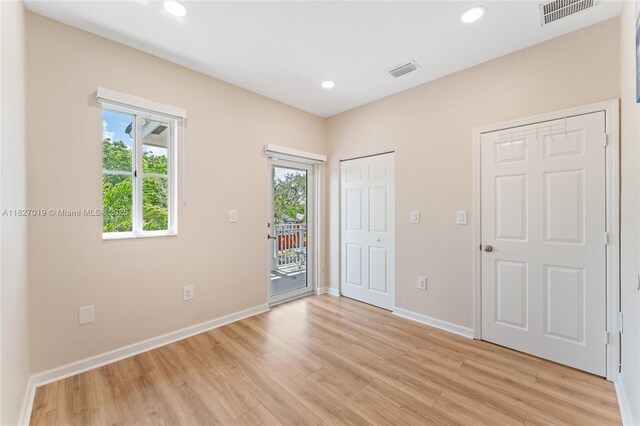 371 NE 32nd Ter, Homestead, FL 33033 - unfurnished bedroom with access to outside, light wood finished floors, and recessed lighting