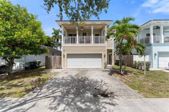 371 NE 32nd Ter, Homestead, FL 33033 - view of front of property featuring a balcony, decorative driveway, an attached garage, and a ceiling fan