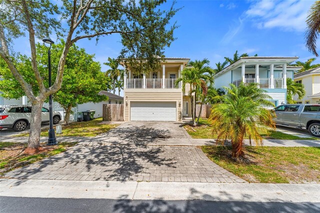 371 NE 32nd Ter, Homestead, FL 33033 - view of front of property with decorative driveway, an attached garage, and a balcony