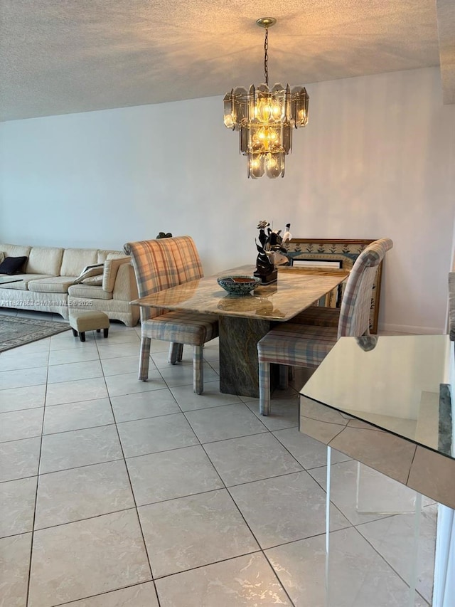 7310 Ashford Pl Unit 304, Delray Beach, FL 33446 - dining area featuring a chandelier, a textured ceiling, and light tile patterned flooring