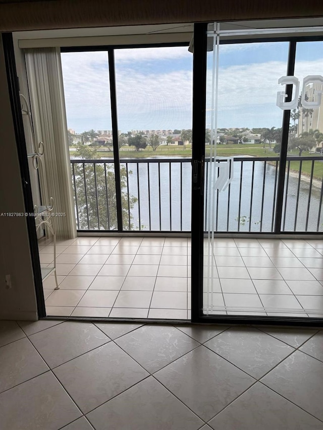 7310 Ashford Pl Unit 304, Delray Beach, FL 33446 - unfurnished room featuring a water view, tile patterned flooring, and healthy amount of natural light