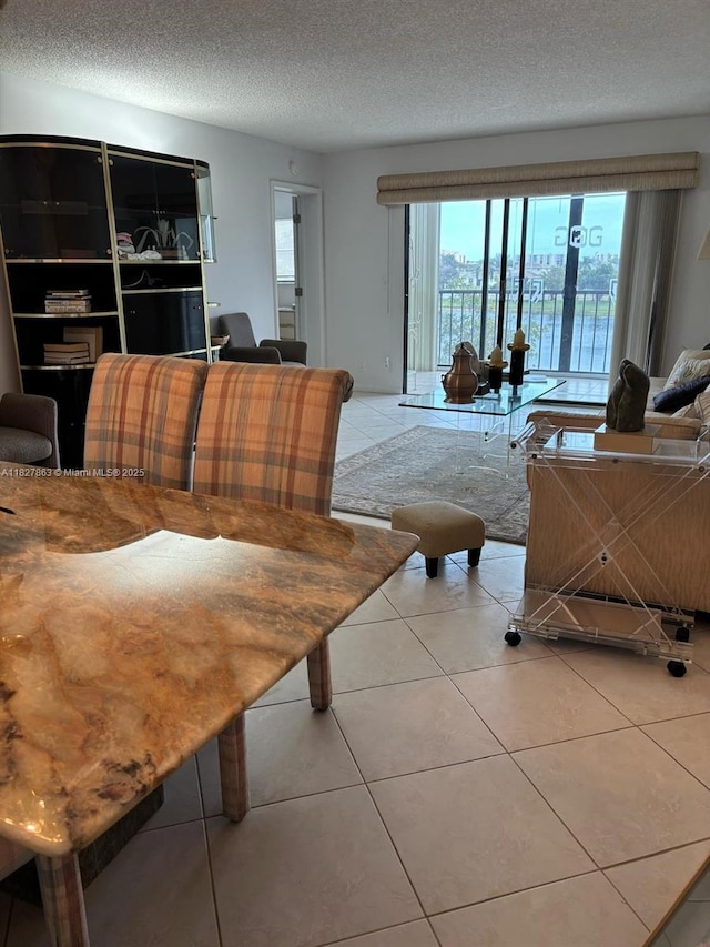 7310 Ashford Pl Unit 304, Delray Beach, FL 33446 - living area featuring light tile patterned floors and a textured ceiling